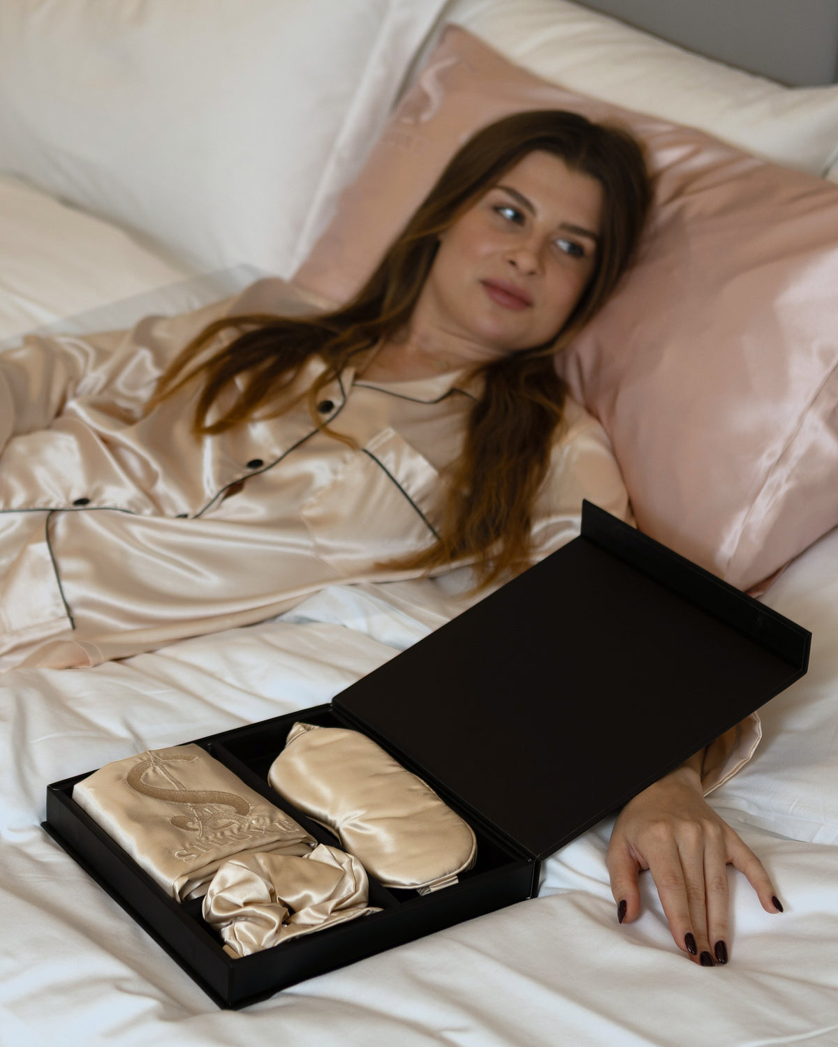 Siluxe silk pillowcase in Gold folded in the Siluxe gift box, with the Gold eye mask and scrunchie