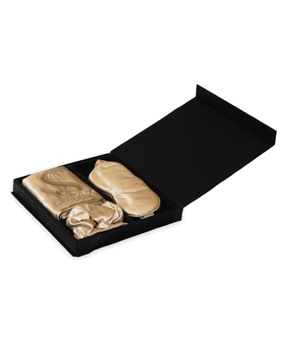 Siluxe GiftBox in Gold, open: silk pillowcase with the embroidered monogram, eye mask and Large scrunchie (the Medium sits beneath it) in the black gift box, on a white background